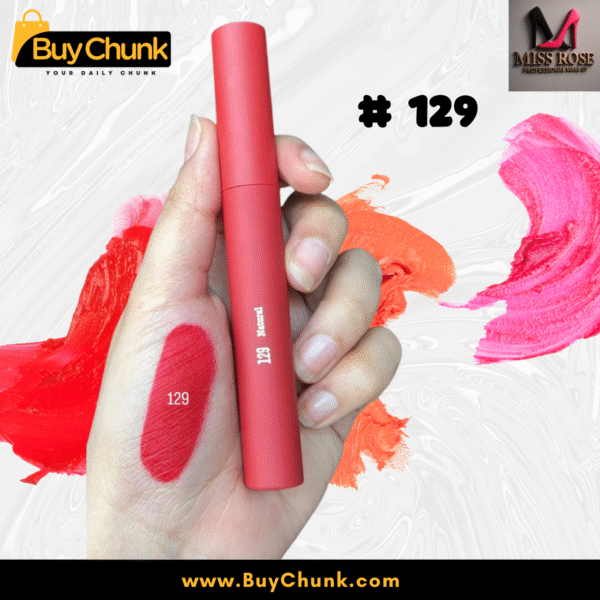 A close-up of a hand swatched with Miss Rose Matte Lip Gloss Shade 129, showing the rich rosy-red color, with the lip gloss tube being held.