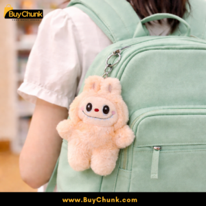 Labubu Peach plush bag charm clipped onto backpack zipper for daily use.